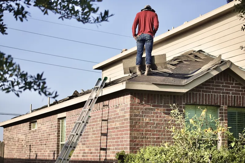 Professional roofer working on a residential roof in Manor View
